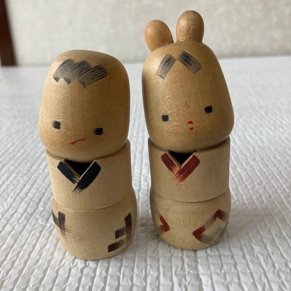 A handcrafted Showa-era wooden Kokeshi doll pair from Japan — authentic folk art with a minimalist, quietly striking aesthetic that looks incredible on a desk or shelf.