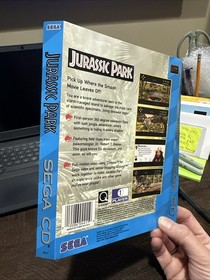 Arte de contraportada de CD Sega solo Jurassic Park da&ntilde;os por agua