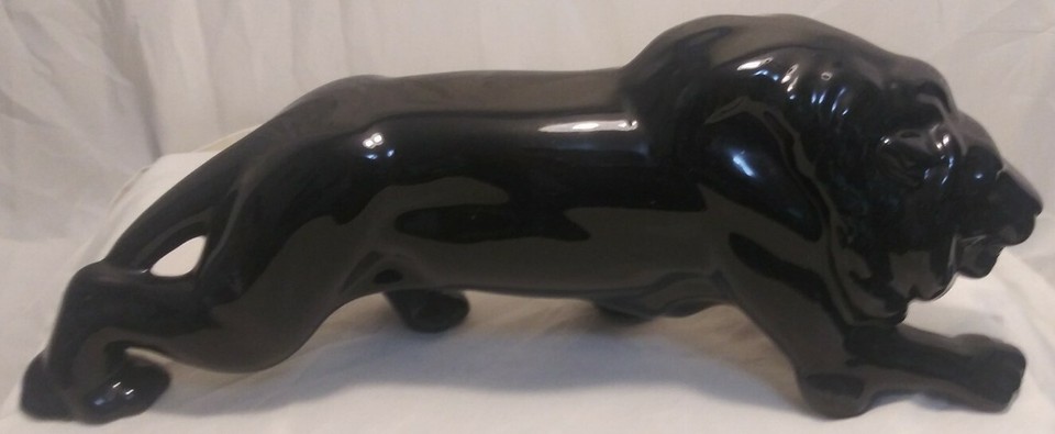 A chunky 1949 black ceramic lion with that bold, graphic MCM silhouette — old enough to be genuinely vintage and striking enough to anchor a shelf.