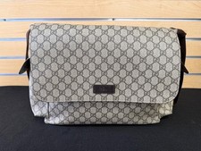 Gucci GG Supreme canvas diaper bag w/ multiple pockets and fold out changing mat