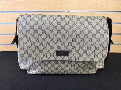 Gucci GG Supreme canvas diaper bag w/ multiple pockets and fold out changing mat