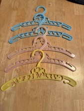 5 VTG PLASTIC CHILDS HANGERS, 2 blue, 2 pink, 1 yellow from 1950s