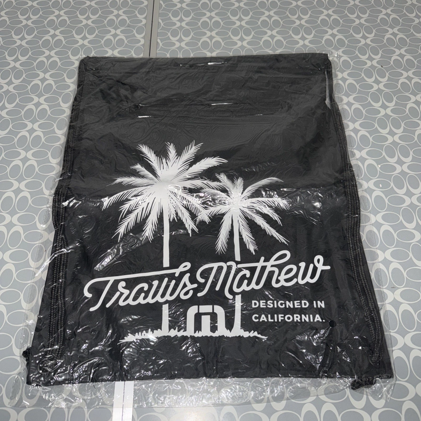 TRAVIS MATHEW 15 BY 18" BLACK BACKPACK "DOESN'T WAIT UNTIL 5 O:CLOCK"