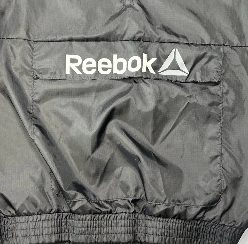 Chaqueta cortavientos Reebok niños 2XL Pullover 1/4 cremallera convertible chaleco para correr usado en excelente estado Foto 2 de 4
