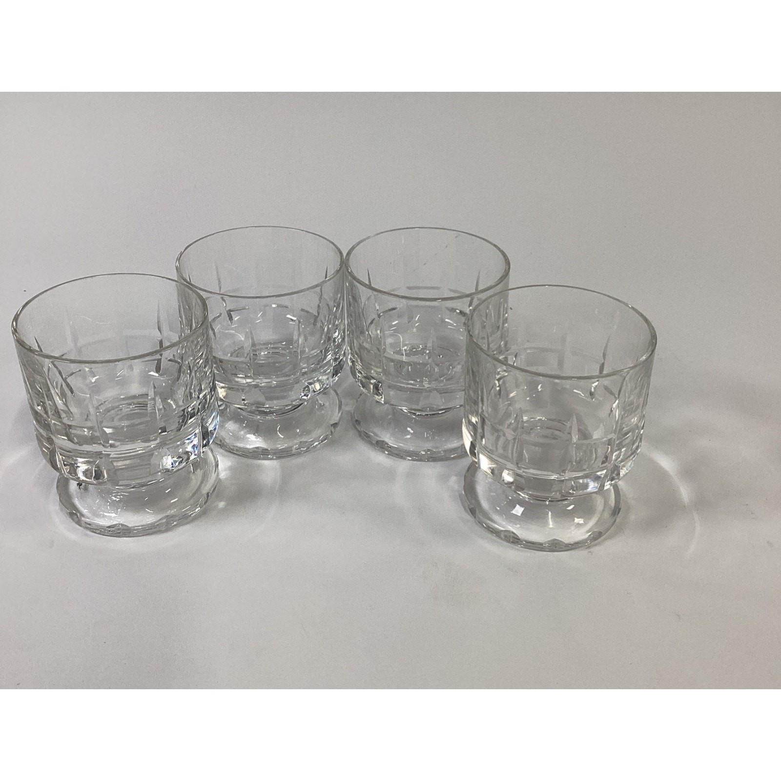 Set of four cut crystal pedestal footed whiskey rocks glasses, mid-century style