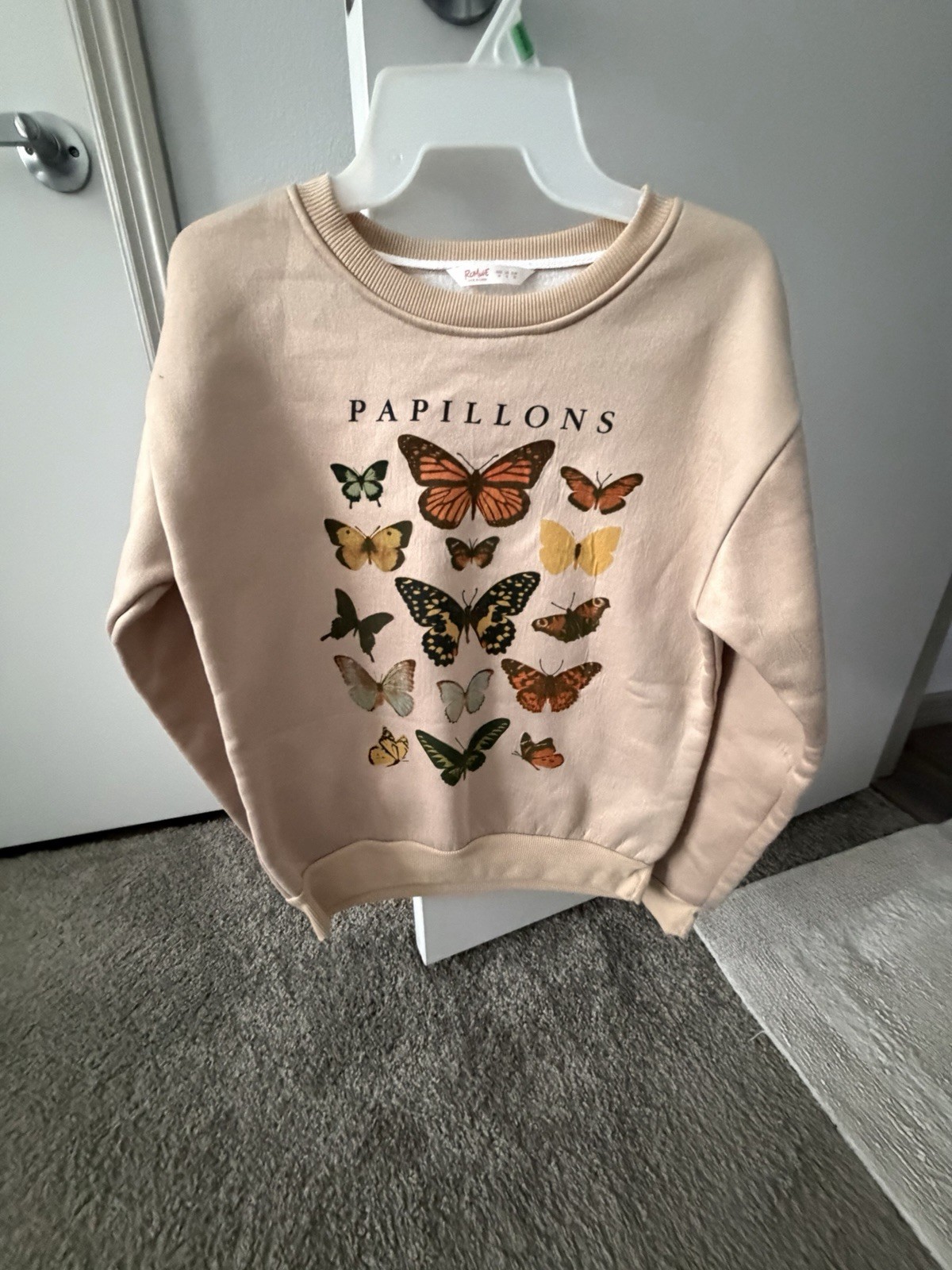 Soft beige women's sweatshirt with colorful butterfly graphic