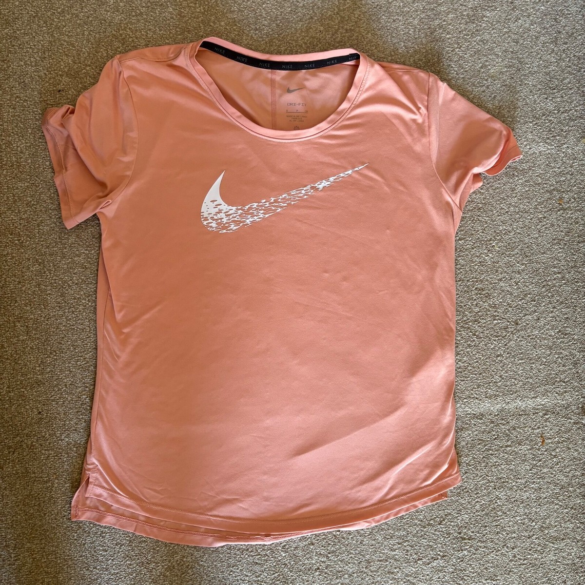 peach color nike shirt