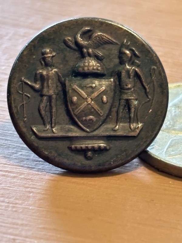 Antique metal Shield of New York button