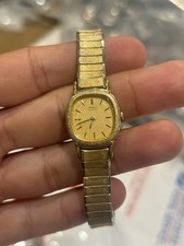 vintage gold-tone Seiko Quartz women's watch with a rounded square dial and a te
