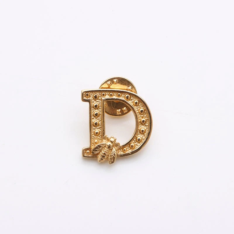 Broche Christian Dior logo doré DS1311 occasion, bijoux élégants cadeaux