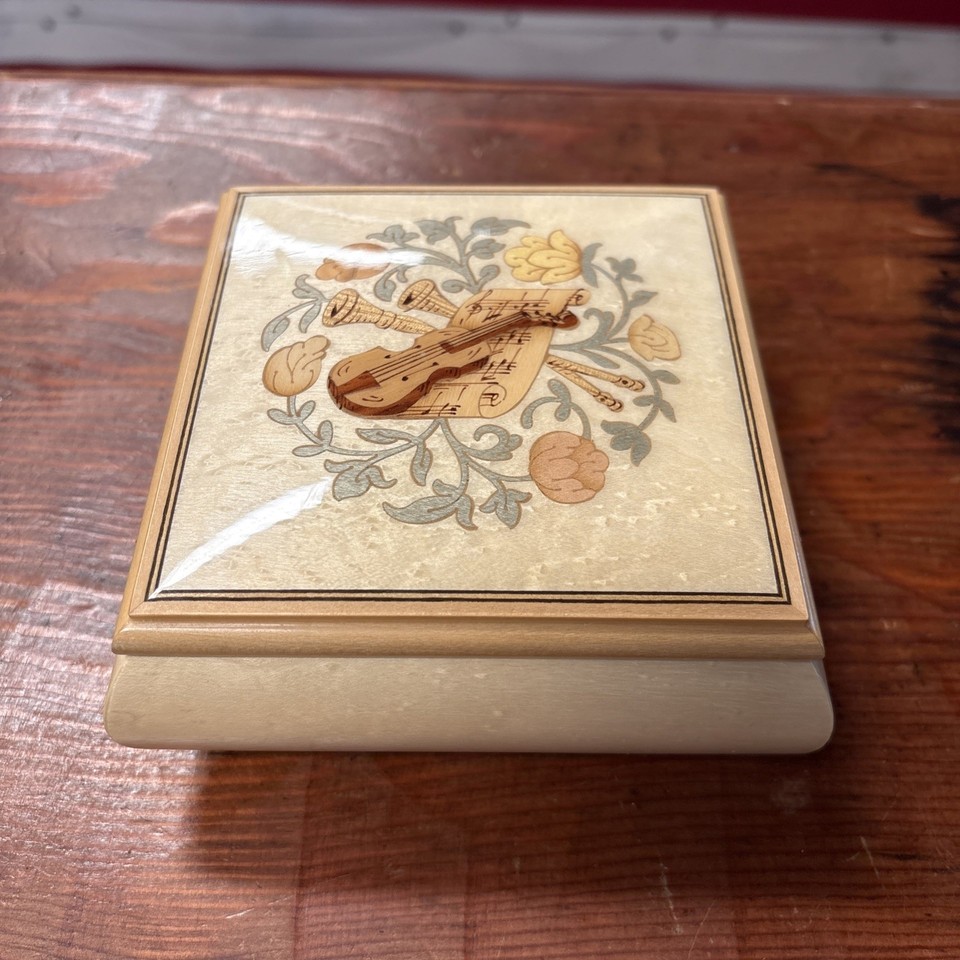 A genuine Swiss Gueissaz-Jaccard wooden music box playing Mozart's Magic Flute — a named Swiss maker puts this in legitimate antique territory.