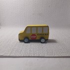 Small, yellow, wooden toy school bus.
