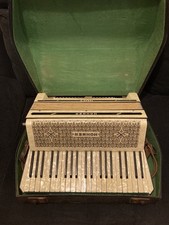 Vintage Hohner Tango III Accordion, with case and music sheets.