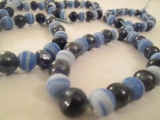 6 STRANDS OF BLUE COMBINATION AGED CERAMIC BEADS - APPROX. 7 INCHES EACH