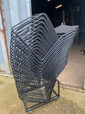 stacking chairs used  black coated steel frame with black fabric seat and back