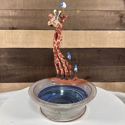 Vintage Pottery giraffe with blue and white birds standing on a pottery bowl