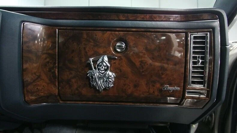 1990 Cadillac Brougham hearse glove box with Grim Reaper decoration