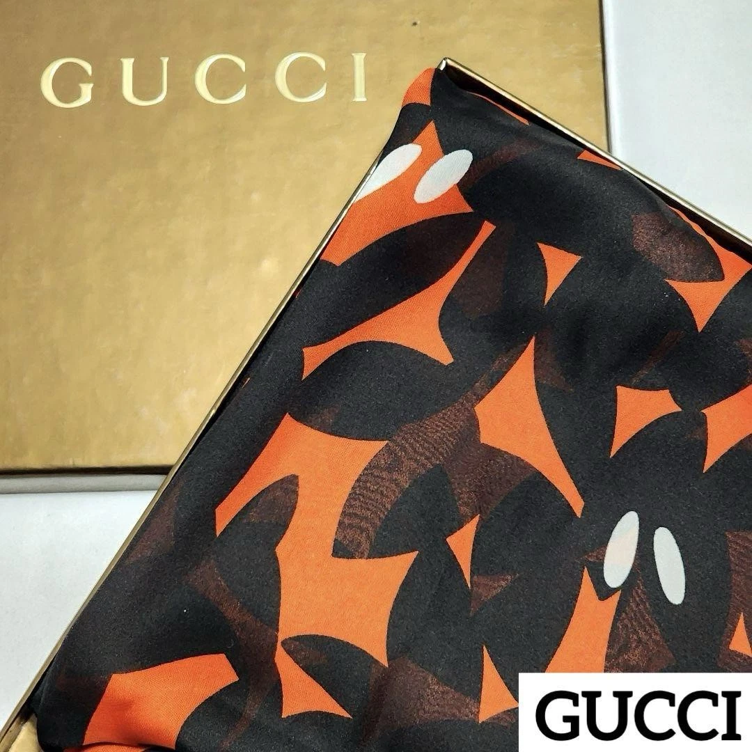 Gucci étole mousseline fleurie noir orange en boîte