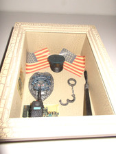 SHADOW BOX REPRESENTING POLICE MEMORABILIA