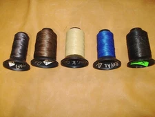 Several partial rolls of X-99 bowstring material