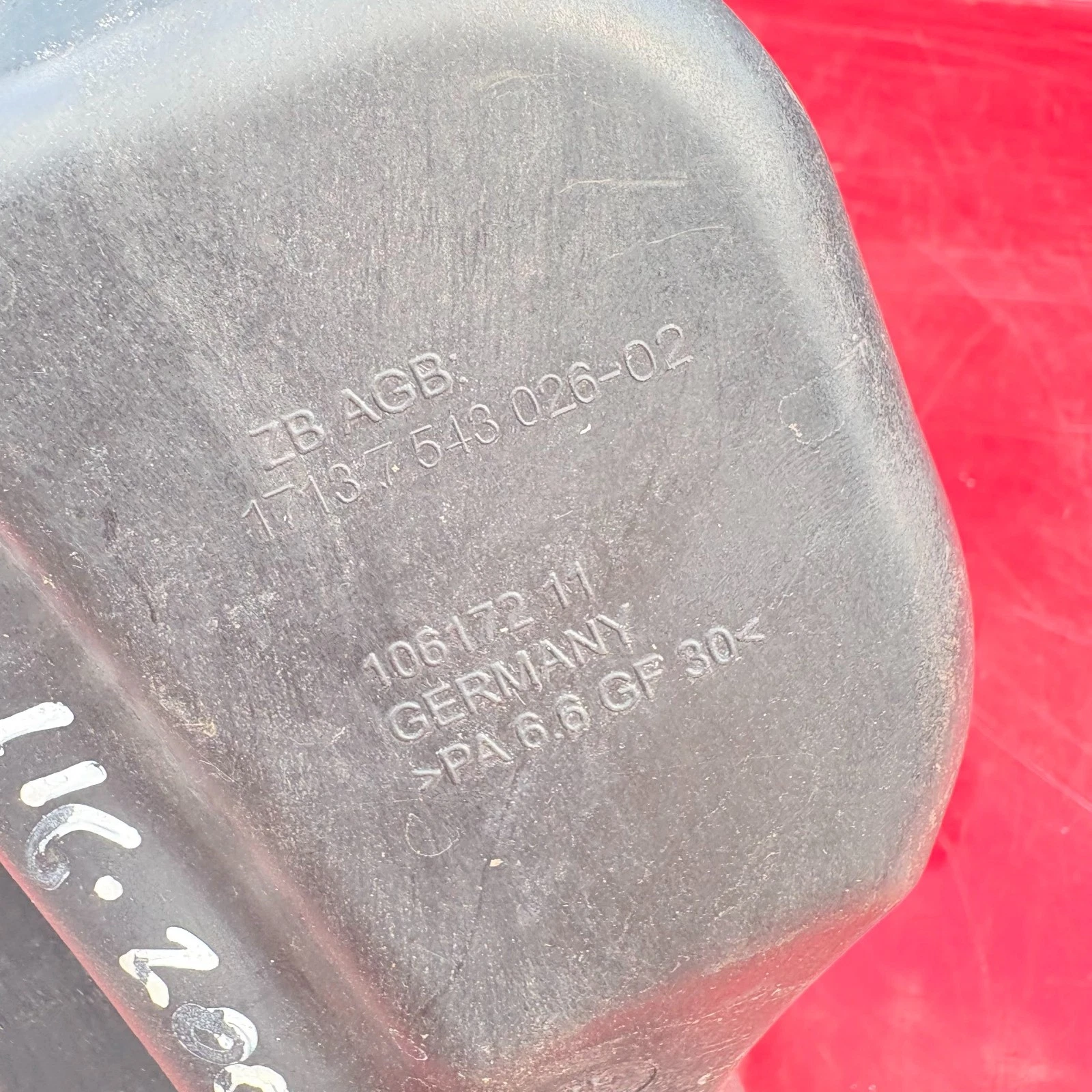 BMW coolant expansion tank showing moulded catalogue number 17137543026 and material marking PA66 GF30