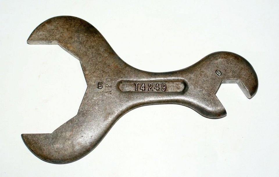 A chunky, cast aluminum double open-end wrench with genuine vintage patina — a conversation-starting desk object or workshop wall piece as much as a working tool.