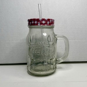 Coca Cola Embossed 16 oz Clear Glass Handled Mug With Checked Lid & Straw Coke