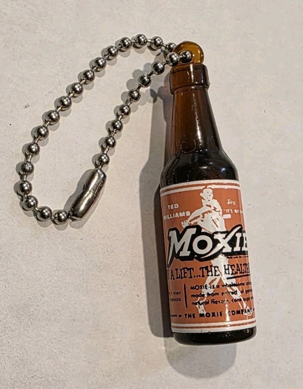 A genuine vintage Moxie soda novelty keychain with Ted Williams branding — a tiny piece of Red Sox and Americana history that fits in a stocking perfectly.