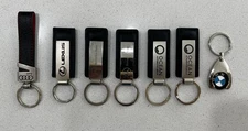 Leather And Metal Keychain With Various Car Brand Names.