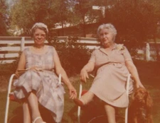 Two Women Smiling Relaxing Outdoors with Dog Friendly Garden Portrait