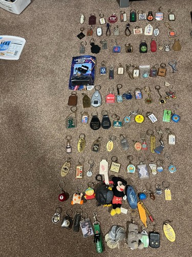 100 key rings very from old to about 10 years old some badges and bits ...