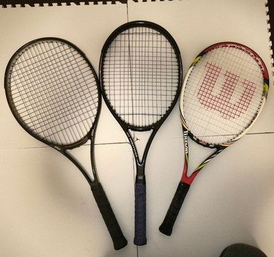 3 tennis rackets, a tennis trainer, and a set of tennis balls