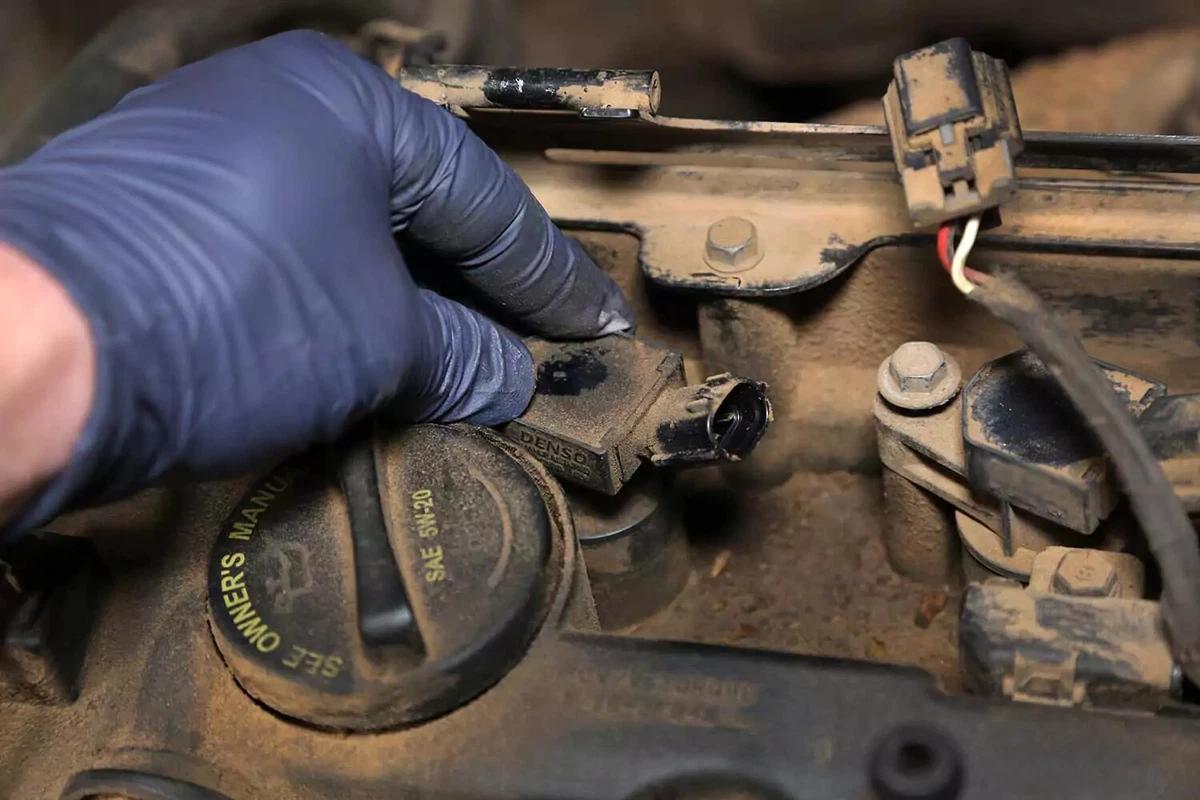 Ignition coil being installed over a new plug.