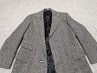Gray wool vintage USA-made TWEED donegal overcoat with notch lapels, front button closure, and two front flap pockets.