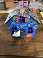preowned Metal haunted house tea light/votice candle holder