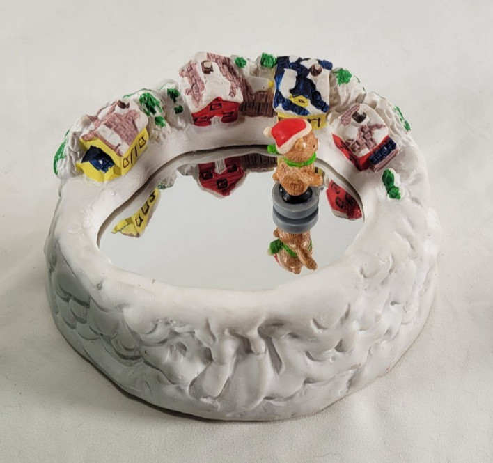 A magnetic skating bear circles a Christmas scene while music plays — this is the kind of holiday heirloom people fight over at estate sales.
