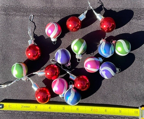 Lot of 16 round Christmas balls with multicolor stripes in red, green, silver, and gold, made in the USA.