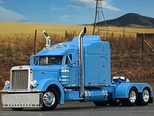 1/64 DCP BABY BLUE PETERBILT 379 W/ 63" MID ROOF SLEEPER W/ WHALE TAIL