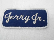 JERRY JR.  USED EMBROIDERED  SEW ON NAME PATCH TAGS WHITE ON DARK BLUE