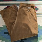 Brown 80s VTG polo cords Ralph Lauren straight-leg pants with button closure, belt loops, and front pockets on patterned rug.