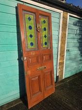 Vintage Victorian-style solid wood front door with stained glass