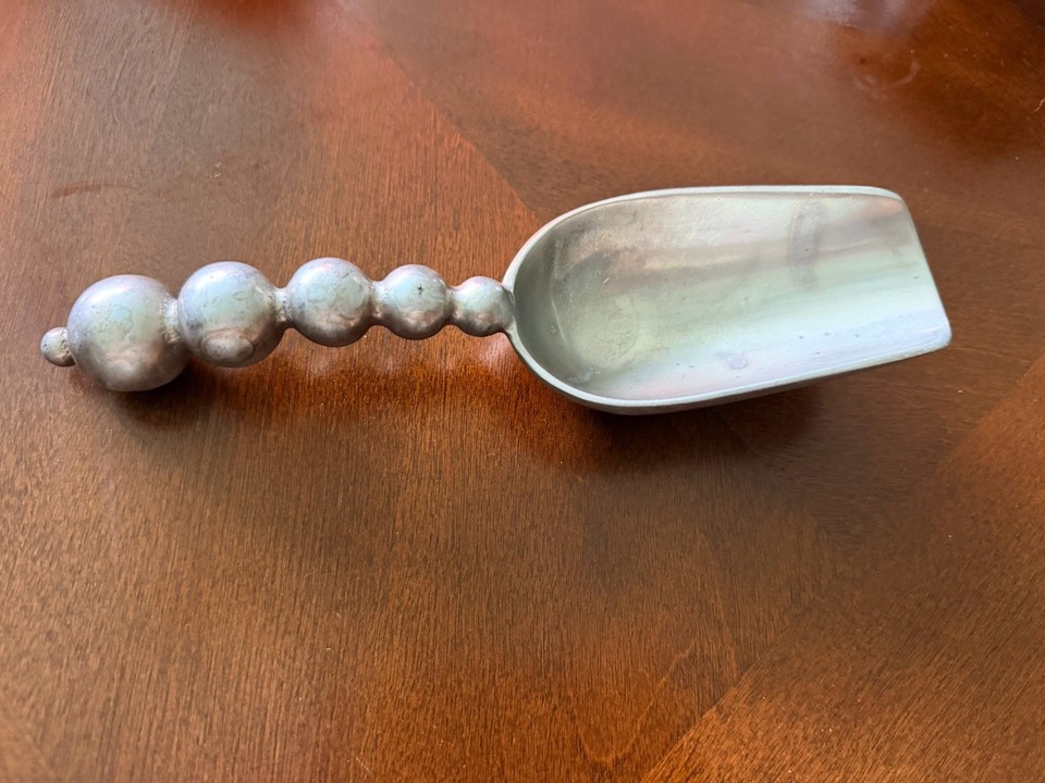 A solid cast-aluminum pearled ice scoop with real vintage heft — the kind of bar tool that makes plastic scoops embarrassing by comparison.