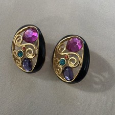 Earrings are vintage gold-tone pierced post earrings featuring black enamel