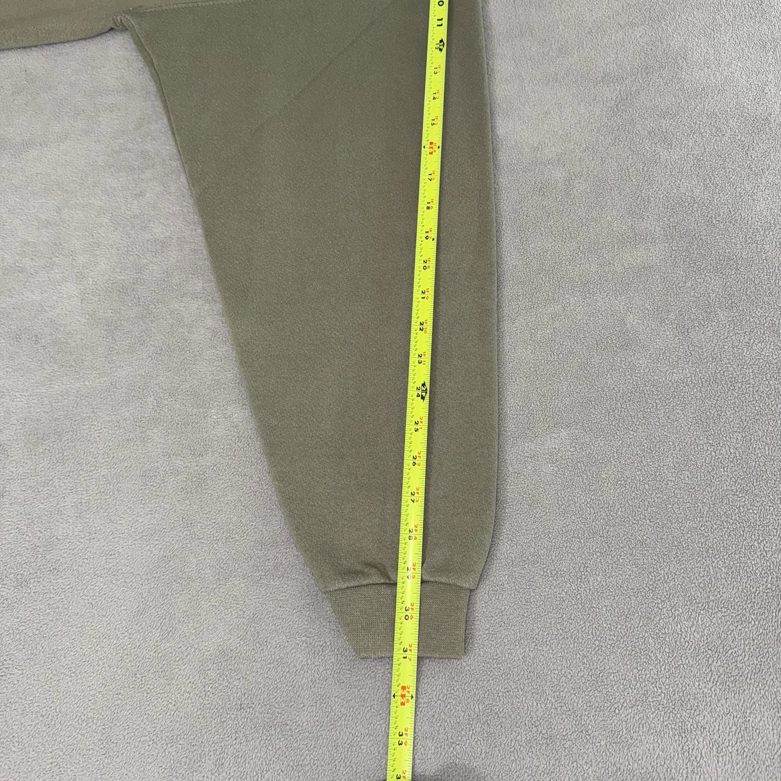 Olive green Eddie Bauer sweatshirt size L, yellow measuring tape along the side, USA made 90s.
