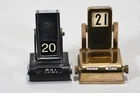 Q91N42- 2x Art Deco desk calendars including brass marked E. Merck (?)