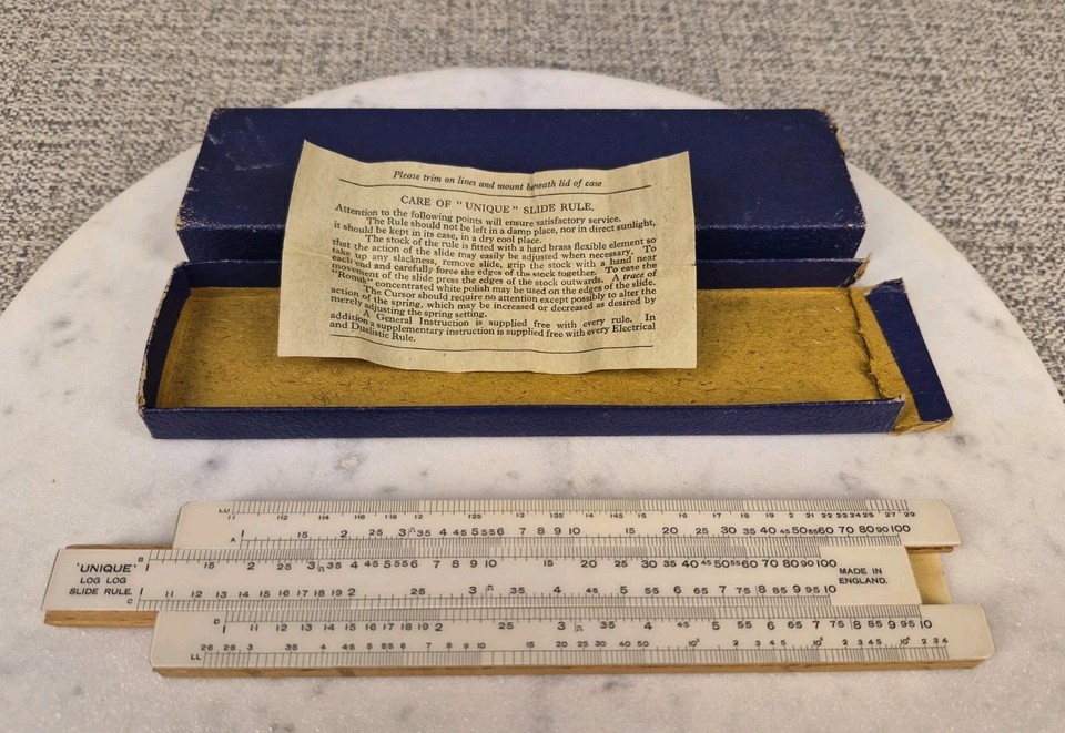A Log Log slide rule made in England, boxed and ready to display — a compact piece of British precision-instrument heritage from the pre-calculator age.