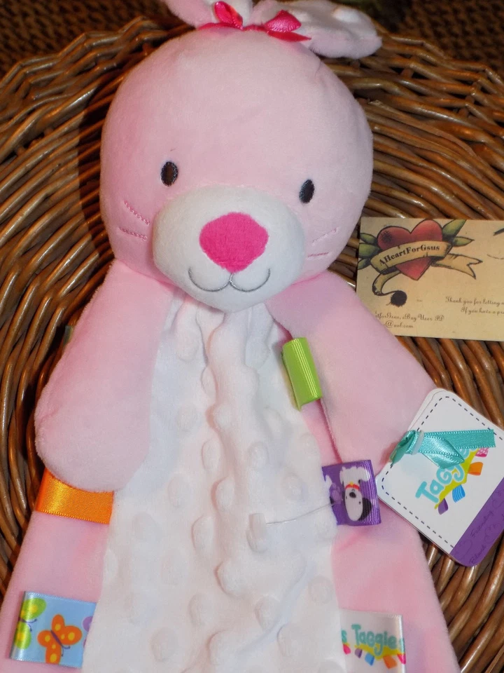 MANTA DE SEGURIDAD TAGGIES CONEJITO CONEJO ROSA COLORIDO FLATSIE MINKY DOT ABDOMEN TAGS Foto 2 de 4