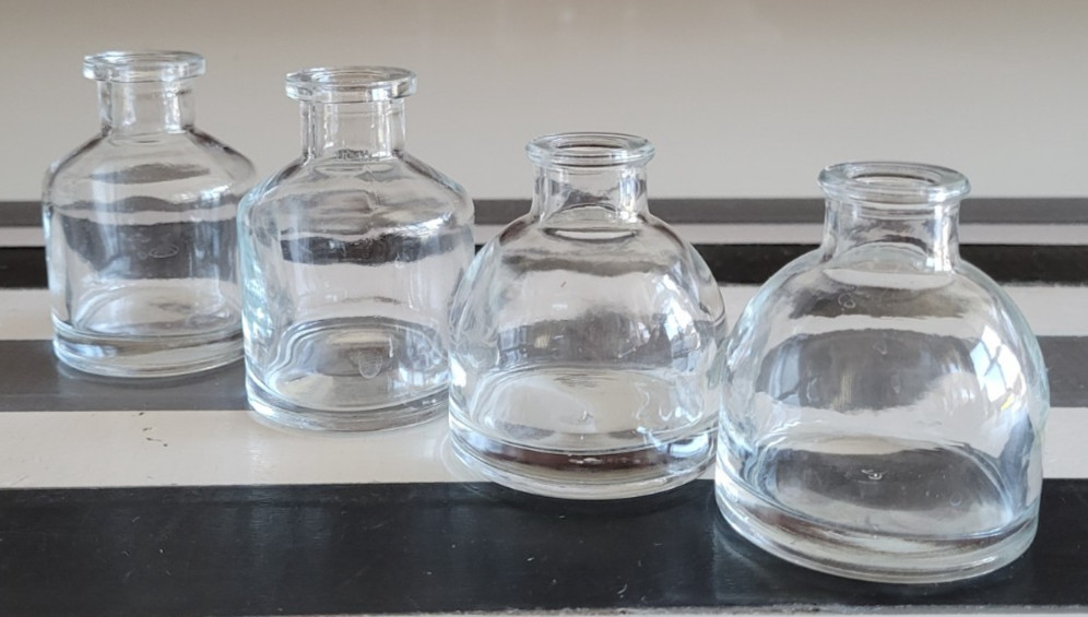 4 CLEAR GLASS MINI DECORATIVE BOTTLES SHORT AND TALL 2.75 AND 3 INCHES