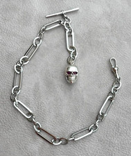 HEAVY SILVER RUBY EYED SKULL WATCH FOB AND SINGLE ALBERT TROMBONE CHAIN.
