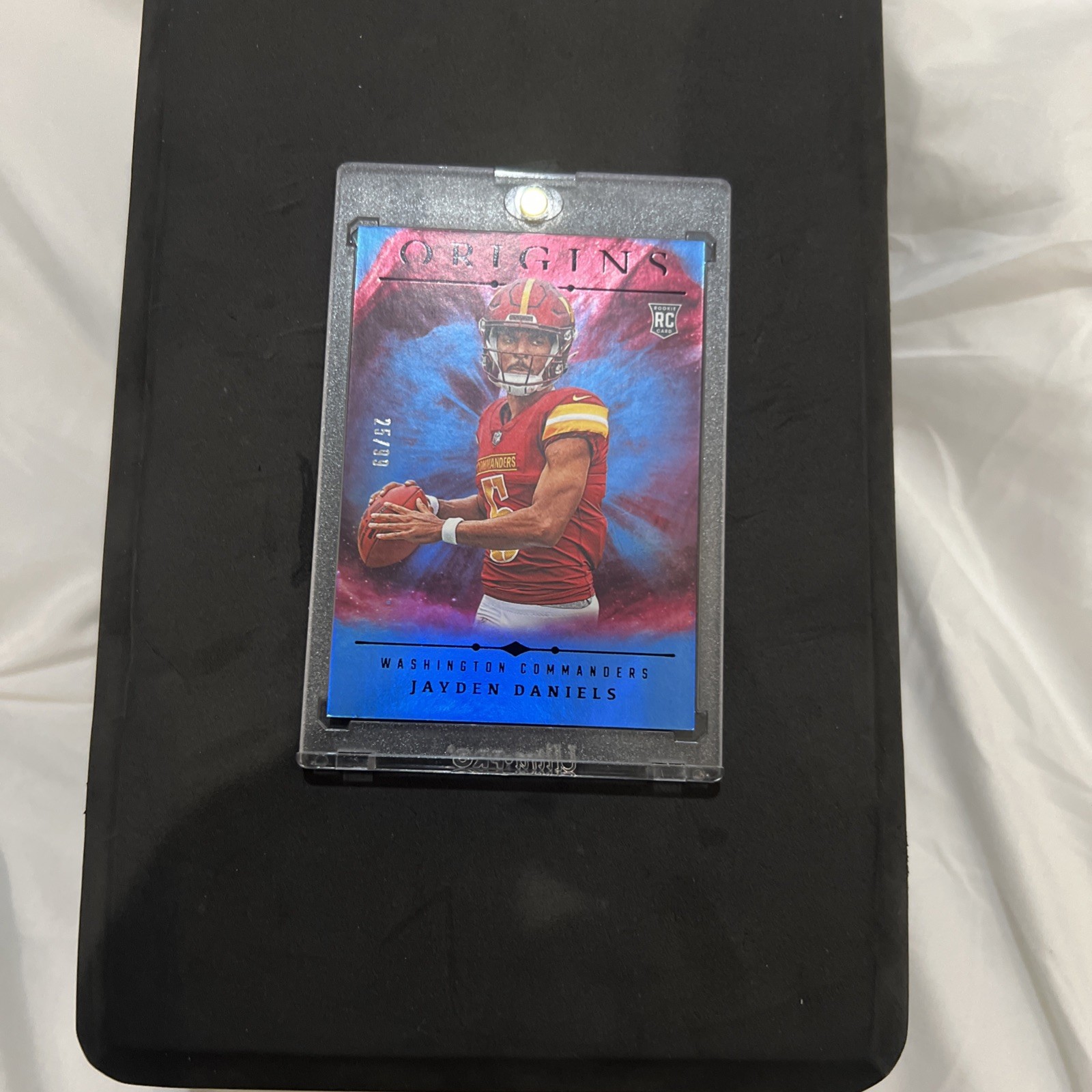 2024 Panini Origins - Rookies Jayden Daniels #144 Holo Blue /99 (RC)